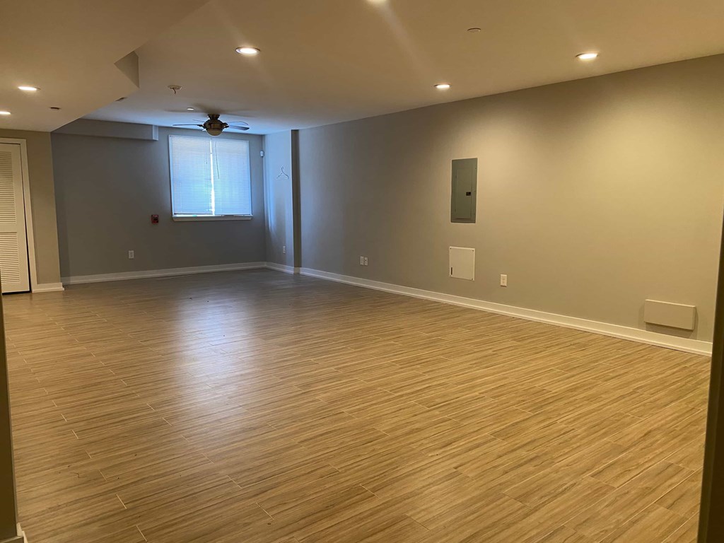 a living room with a hard wood floor and a window