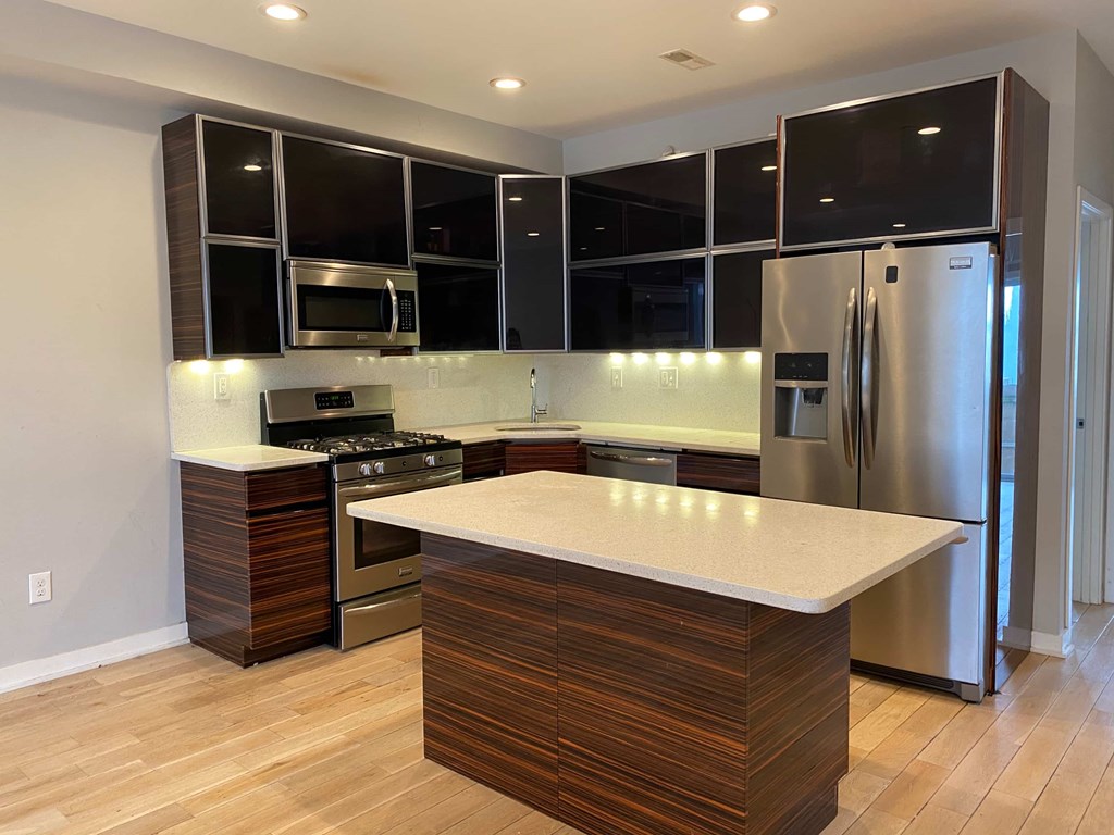 a kitchen with stainless steel appliances and a counter top