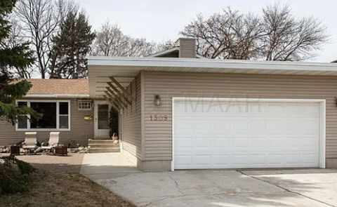 A house with a garage door that says "MARATHON" on it.
