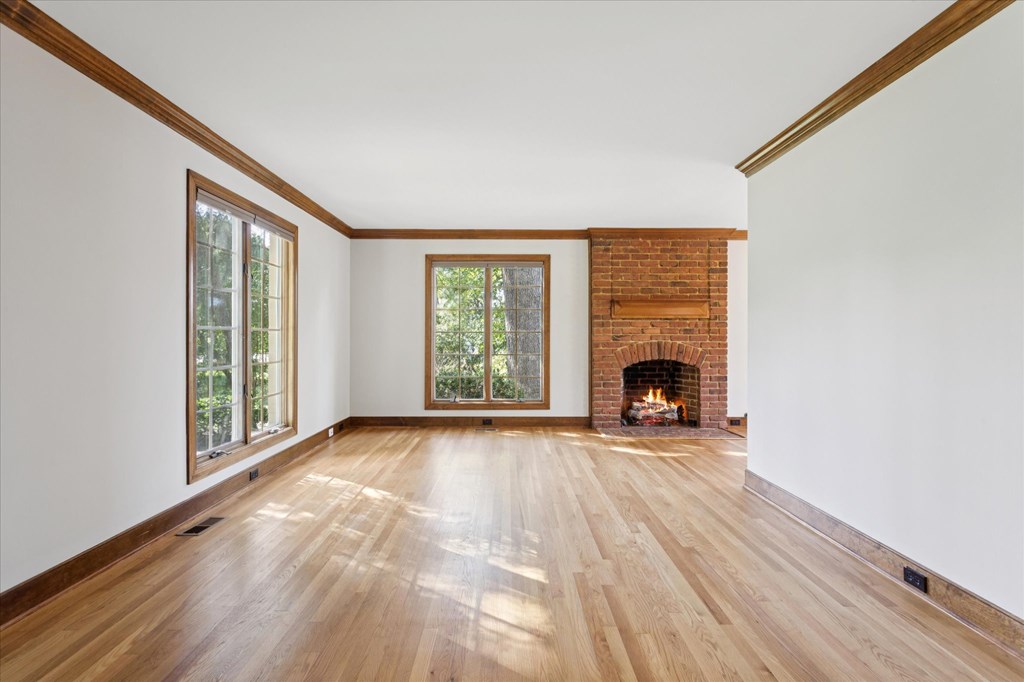 A room with a fireplace and wooden floors.