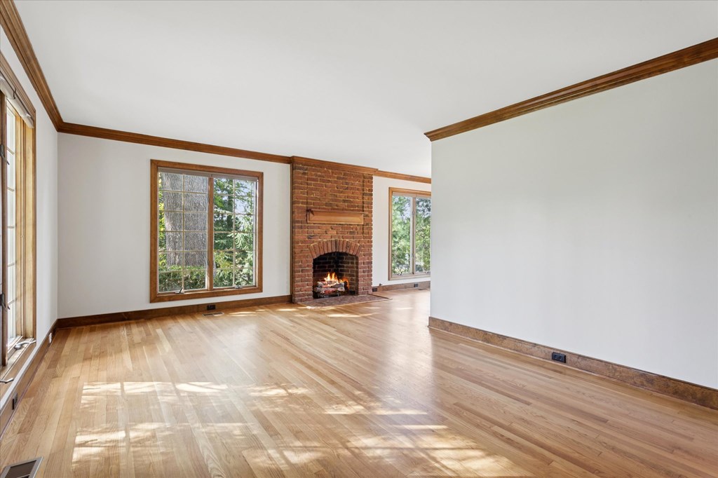 A room with a fireplace and a window.