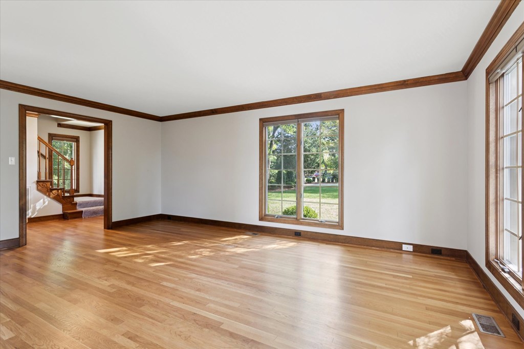 A room with wooden floors and white walls.