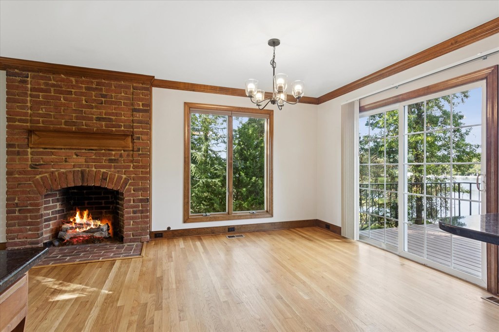 A room with a fireplace and a chandelier.