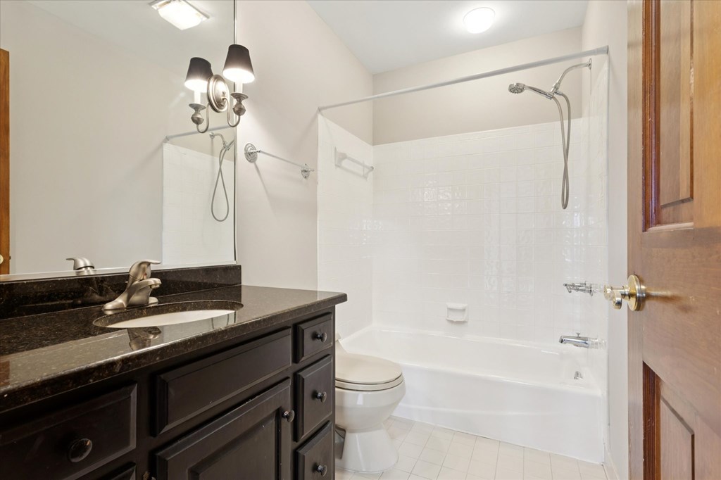 A bathroom with a sink, toilet, and bathtub.