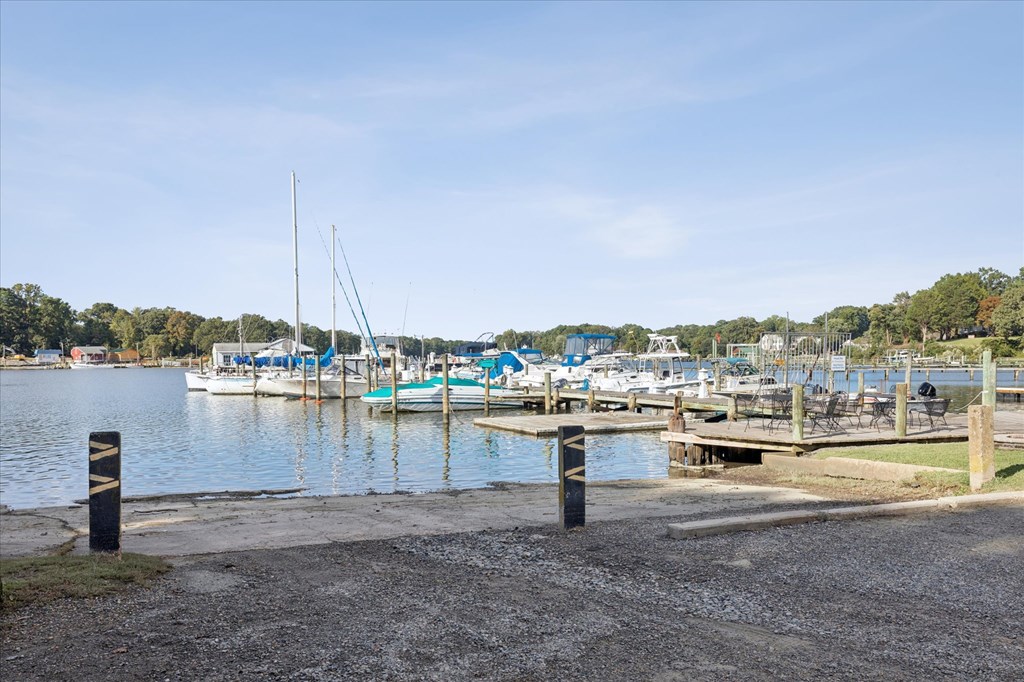 A marina with boats docked and a clear sky.