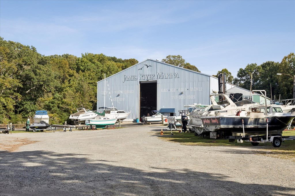 A boat is parked in front of a large building with the name "Evergreen Marine" on it.