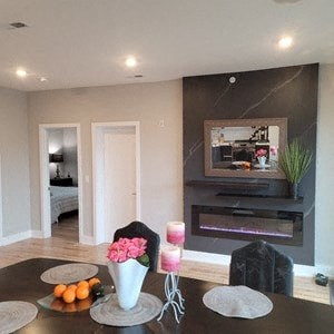 a living room with a table and a fireplace