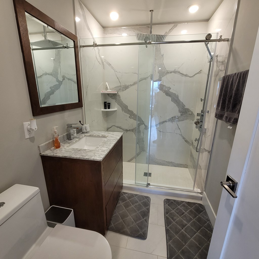 a small bathroom with a shower and a sink and a toilet