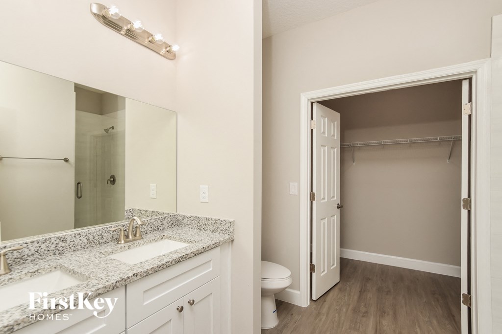 a bathroom with a sink and a mirror and a toilet