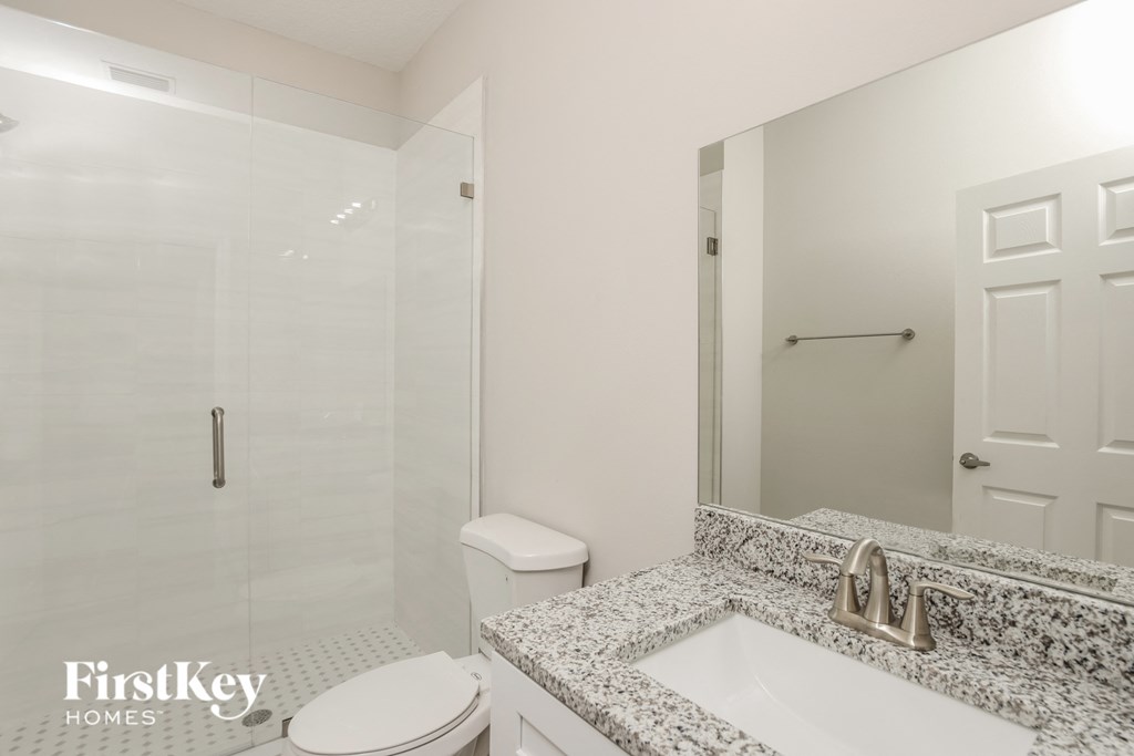 a bathroom with a sink and a toilet and a shower