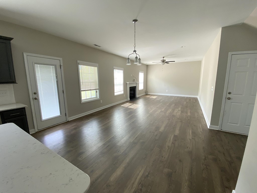 A room with wooden floors and a ceiling fan.