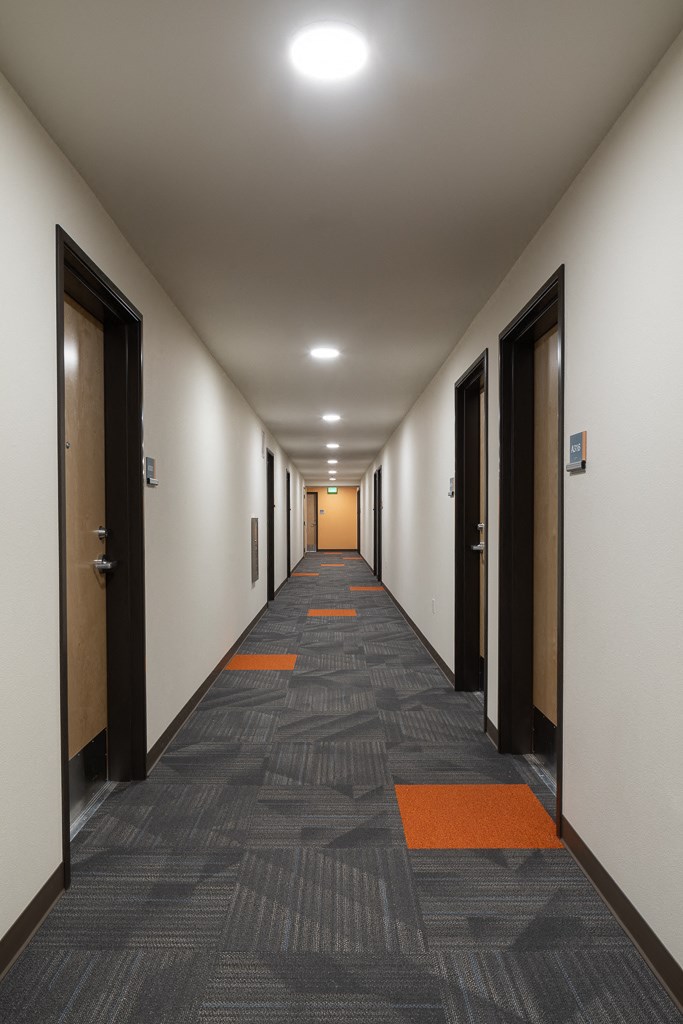 a long corridor with doors in a building