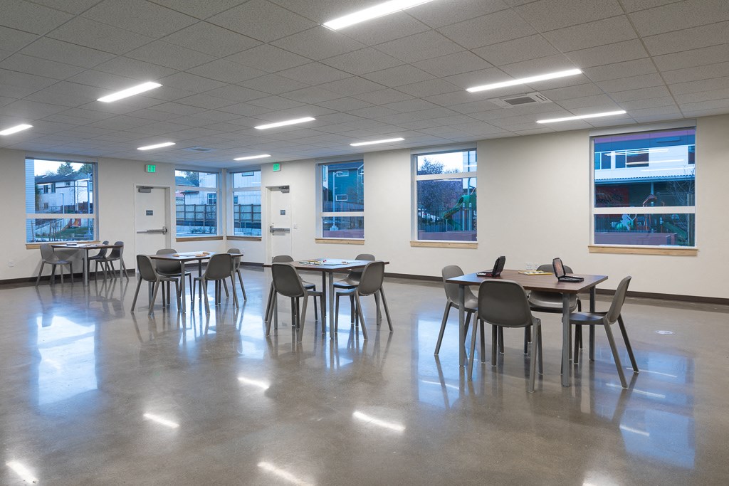 a large room with tables and chairs in the center of it
