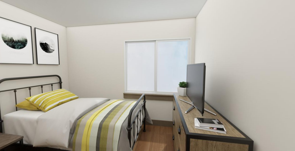 a bedroom with a bed and a tv