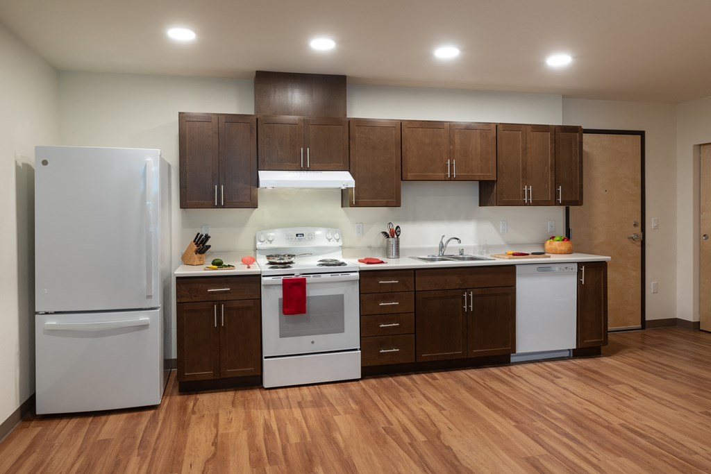 a kitchen with white appliances and brown cabinets