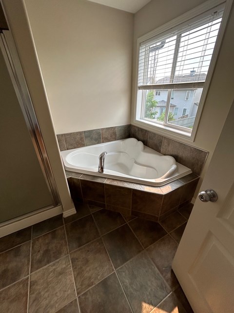 a large soaking tub in a bathroom with a window