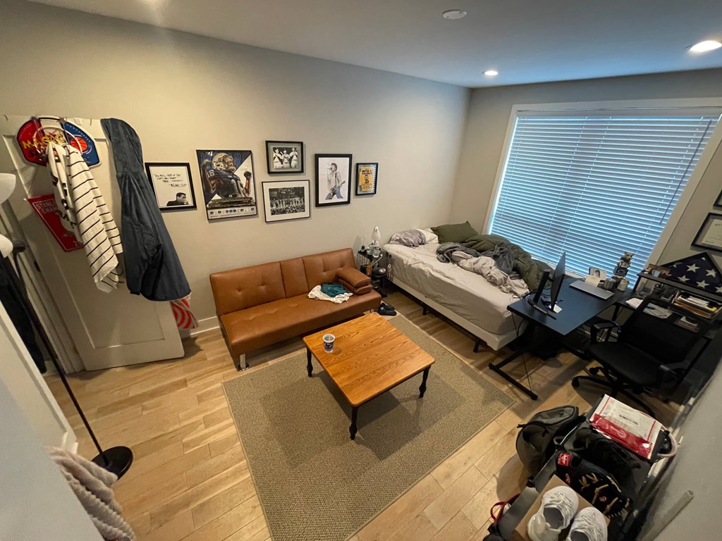 a living room with a couch and a table and a bed