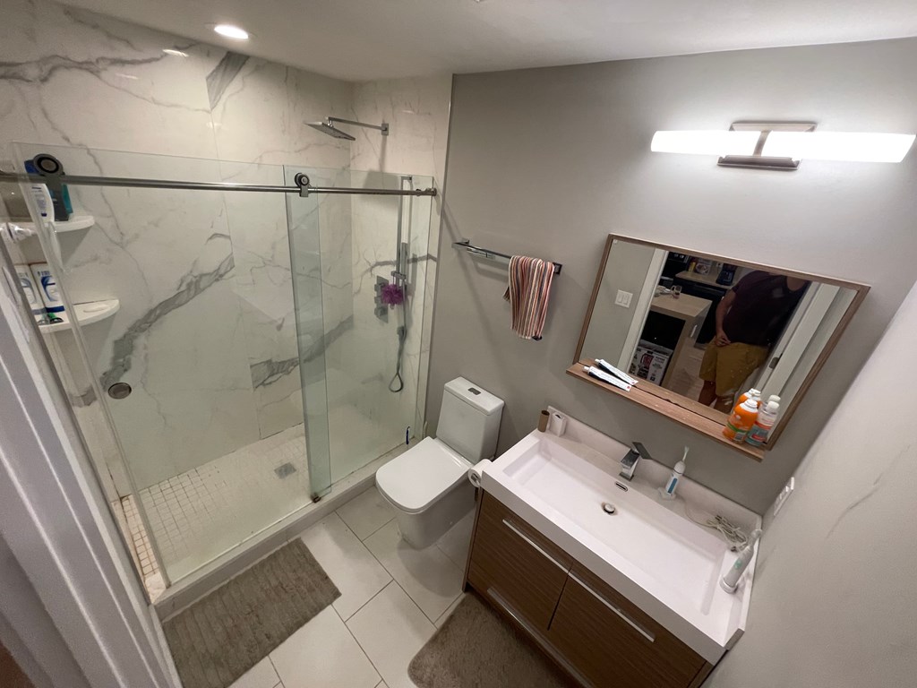 a bathroom with a sink toilet and a shower