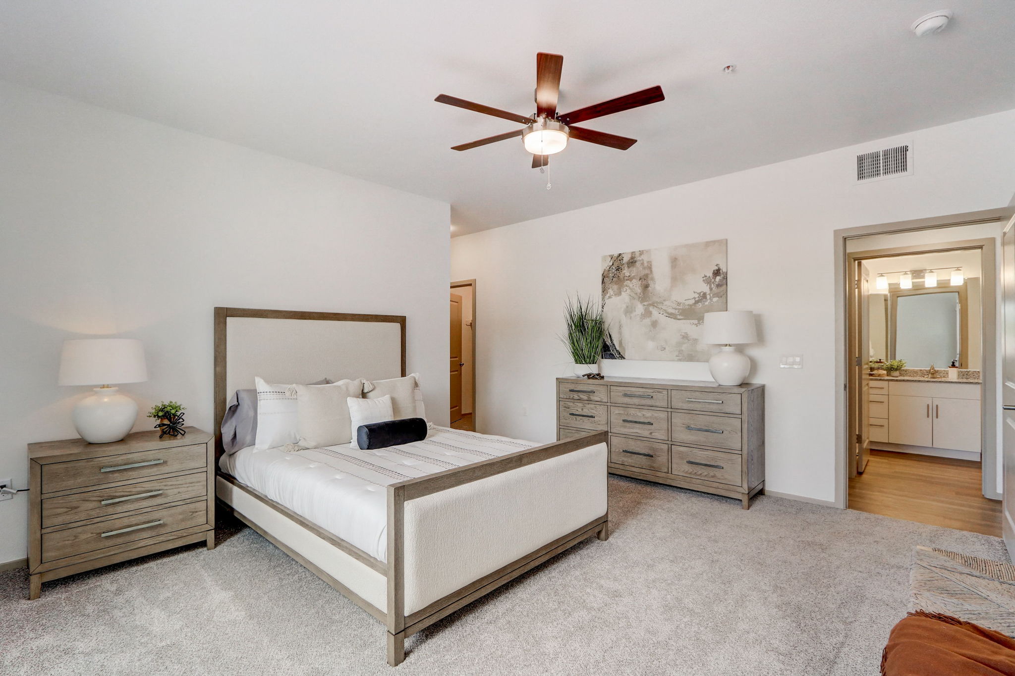 a bedroom with a bed and a ceiling fan