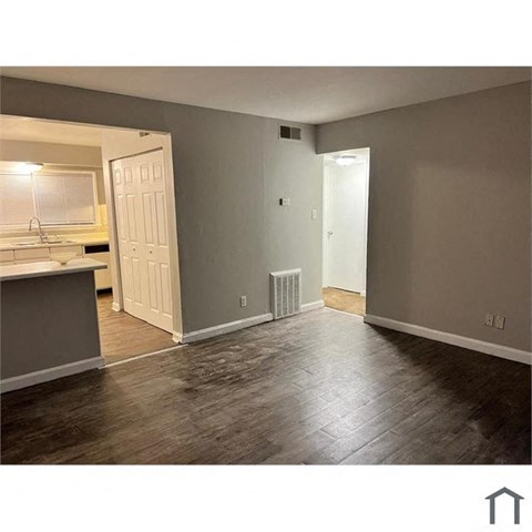 A room with a wooden floor and a white door.