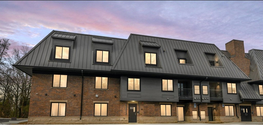 a large brick building with a black roof
