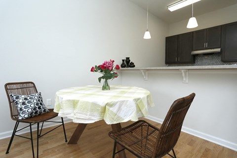 A dining room with a round table and chairs.