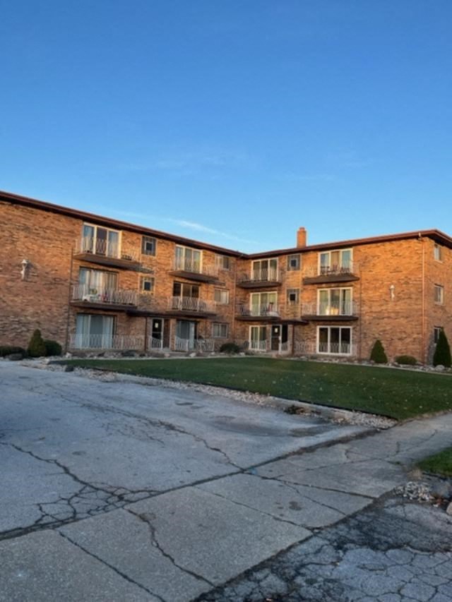 a large brick apartment building on the side of a street