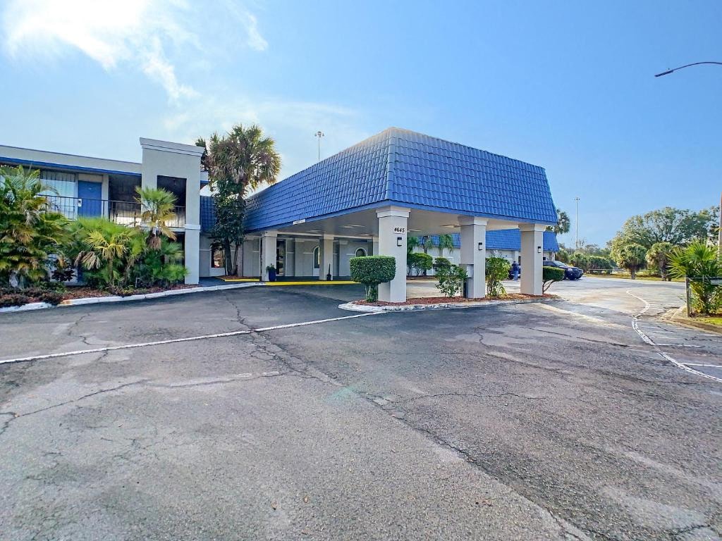 a building with a blue roof and a parking lot