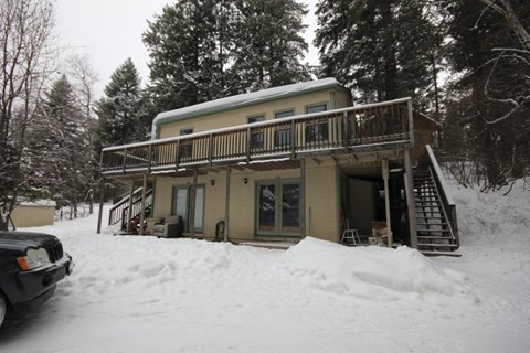 A house with a balcony covered in snow.
