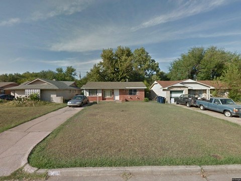 a neighborhood of houses with cars parked in front of them