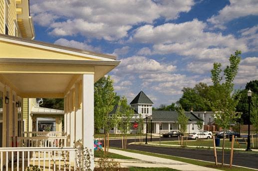 a house with a porch and a street with cars