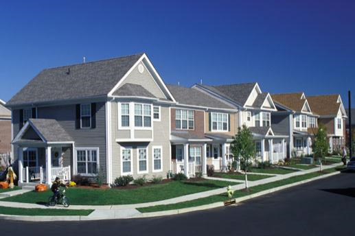 A row of houses with a clear blue sky above them.