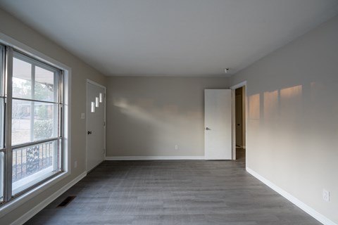 A large empty room with a door on the right side.