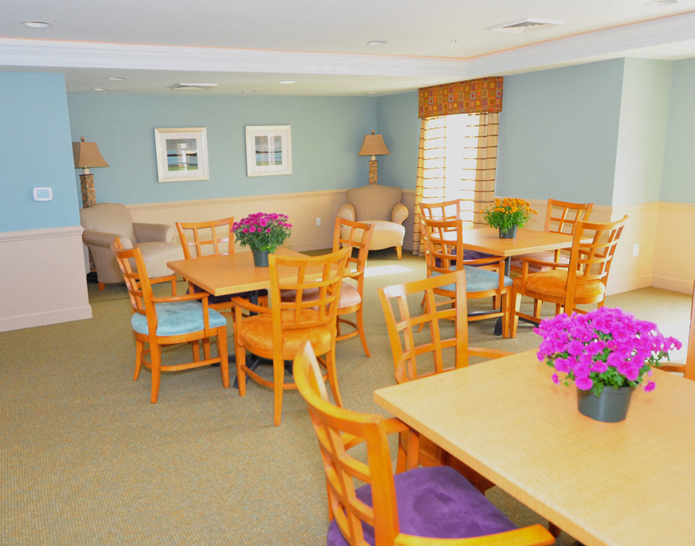 a dining room with tables and chairs and a couch
