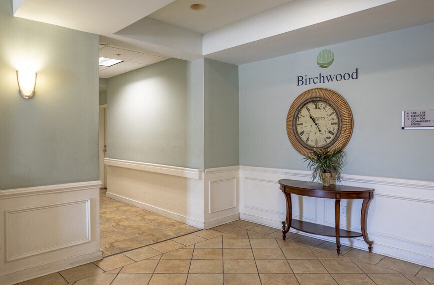 a large clock on the wall in the lobby of a building