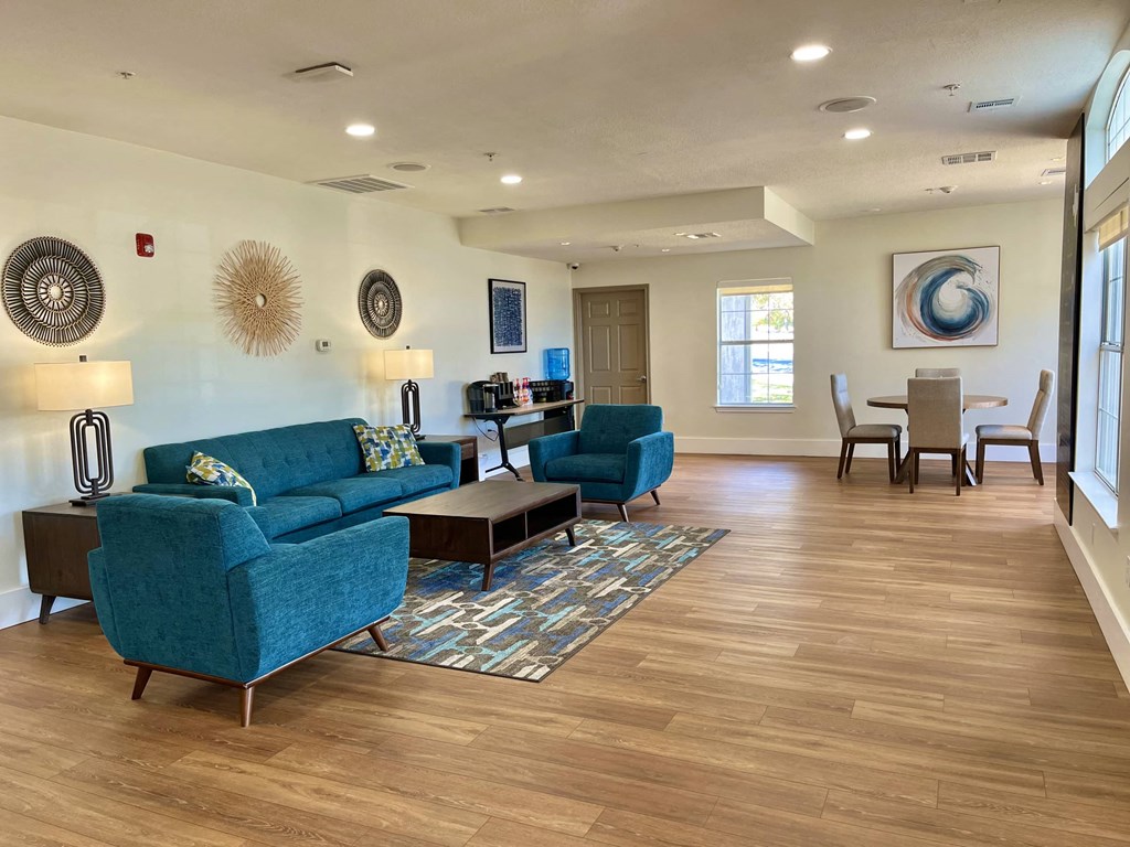 a living room with couches and chairs and a dining room table