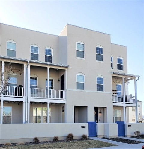 the exterior of an apartment building with balconies and windows