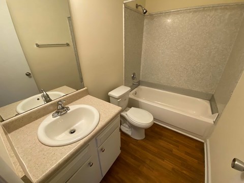 A bathroom with a sink, toilet and bathtub.