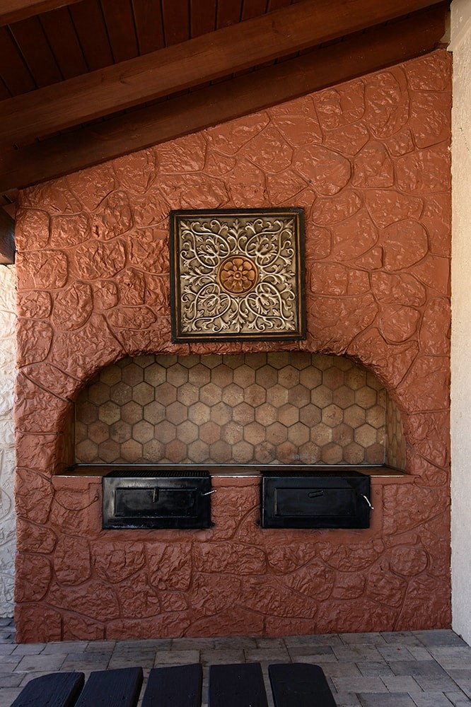 a living room with a fireplace and a painting on the wall