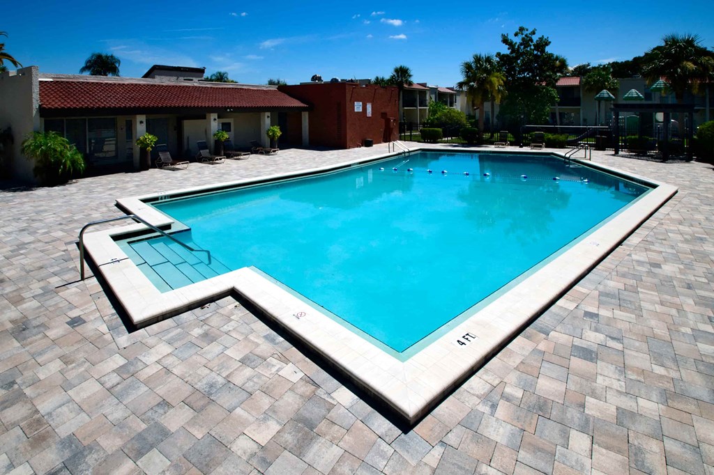 a swimming pool in the middle of a resort style pool