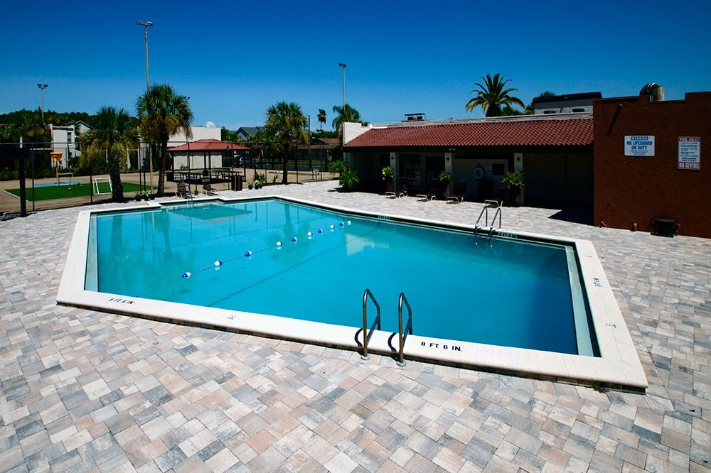 a swimming pool at a house with a resort style pool