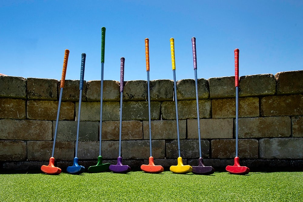 a row of colorful shovels sitting next to a wall