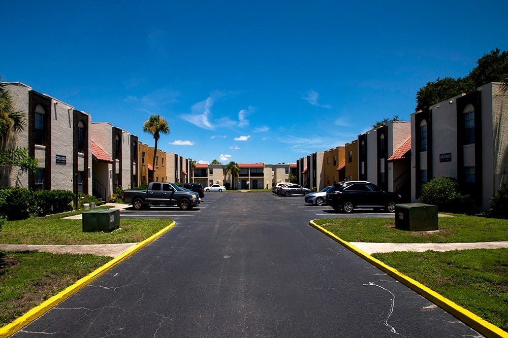 a street with rows of buildings and cars on it