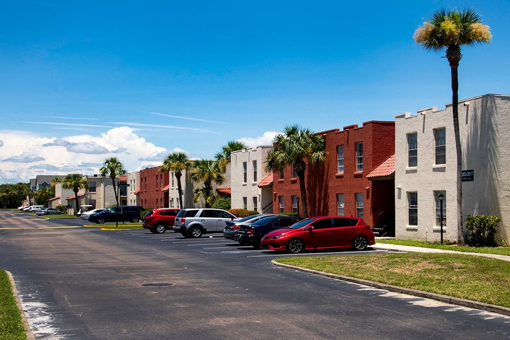 a city street with cars parked in front of buildings