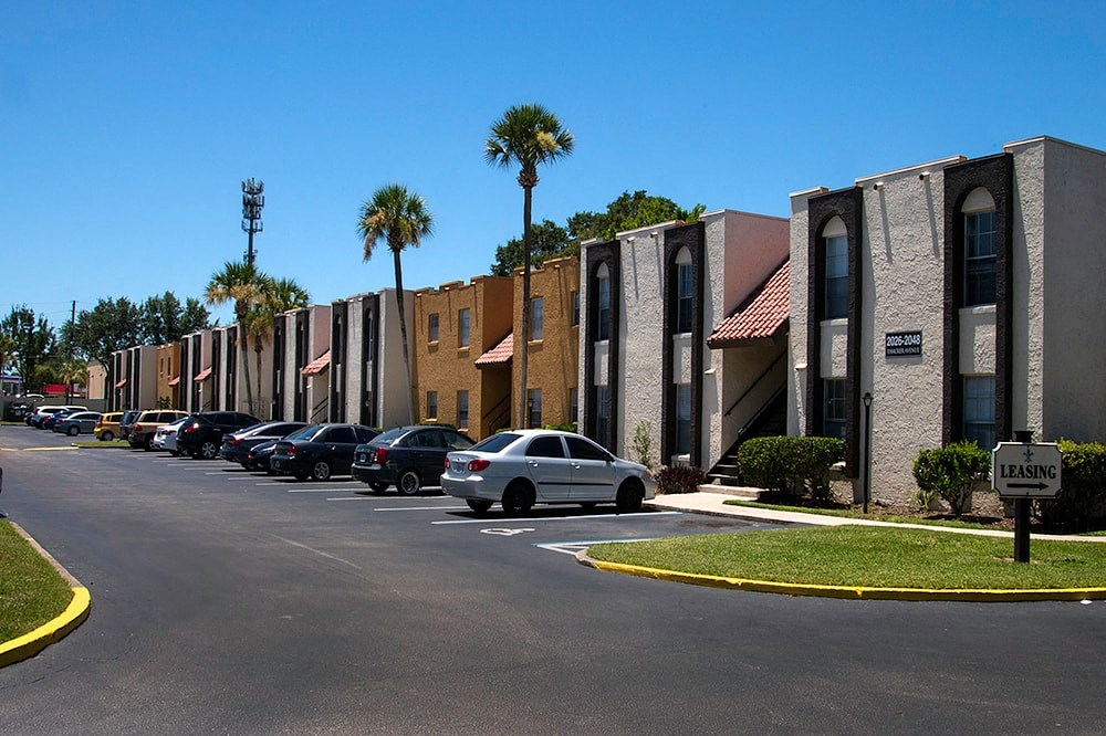 a city street with cars parked in front of buildings