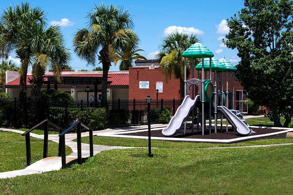 a playground with two slides in a park