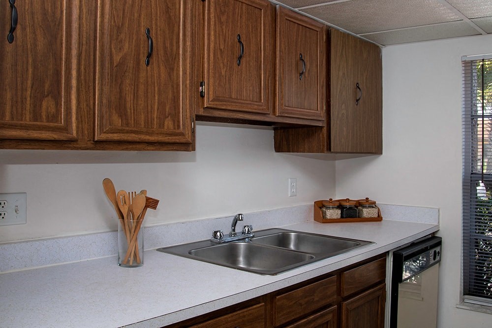 a kitchen with a sink and wooden cabinets