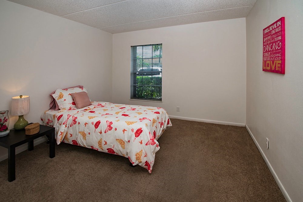 a bedroom with a bed and a window