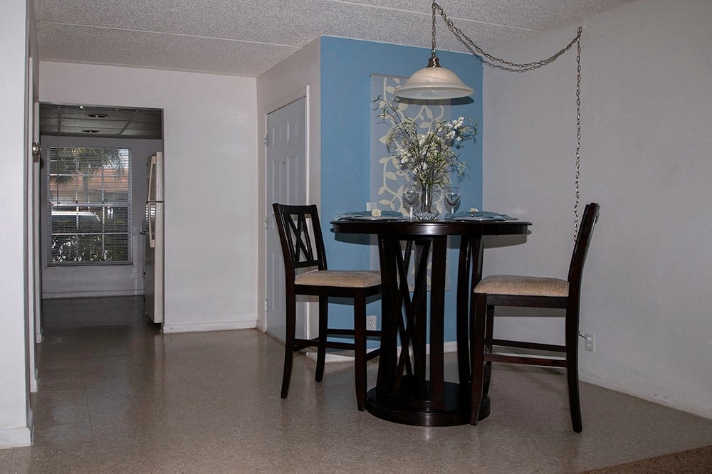 a dining room with a table and chairs