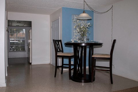 a dining room with a table and chairs